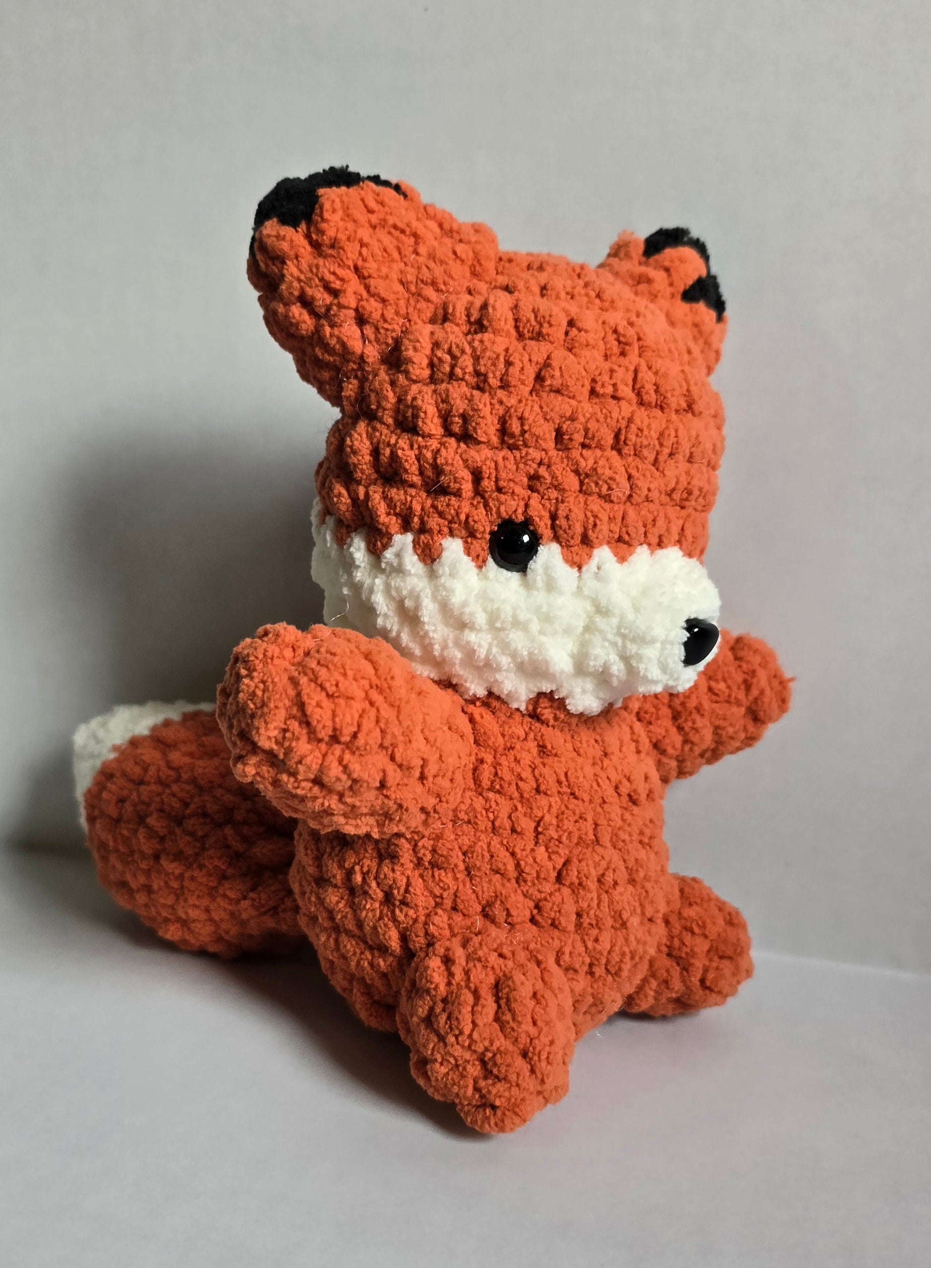 Crocheted orange and white fox plushie
