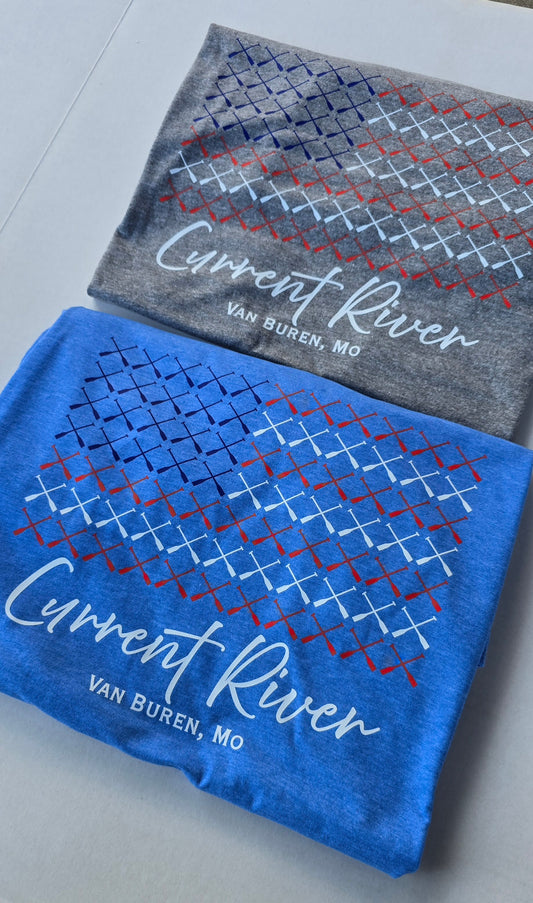 Heather gray and heather blue t-shirts with a graphic design of multiple canoe paddles arranged to look like a US Flag. The text "Current River Van Buren, Mo" is at the bottom. 